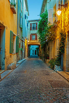 Narrow street in the old town Antibes in France by Laborant